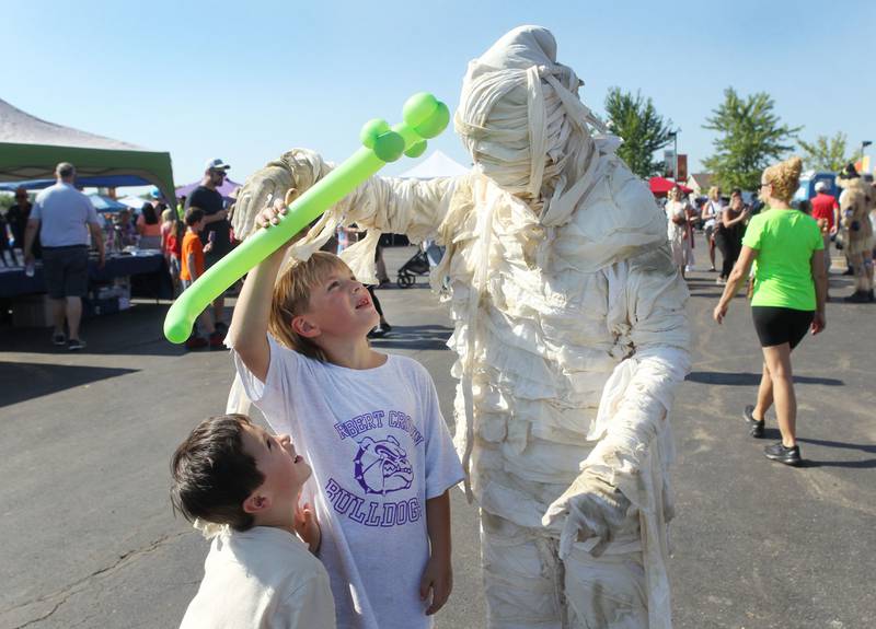 Evan Isom, 5, of Volo stands next to Dax Mathewson, 7, of Wauconda as he shows a mummy his balloon during the Fall Festival at Grant Township Center on October 1st in Ingleside. The event was sponsored by the Village of Fox Lake and Grant Township.
Photo by Candace H. Johnson for Shaw Local News Network