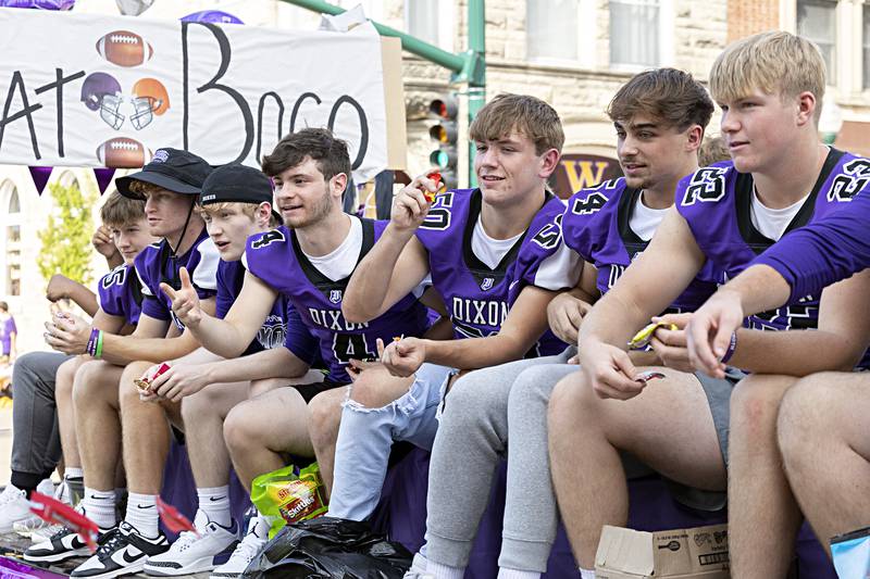 Dixon footballers fire candy from their float Friday, Sept. 29, 2023. The team will take on Winnebago tonight in the homecoming game.