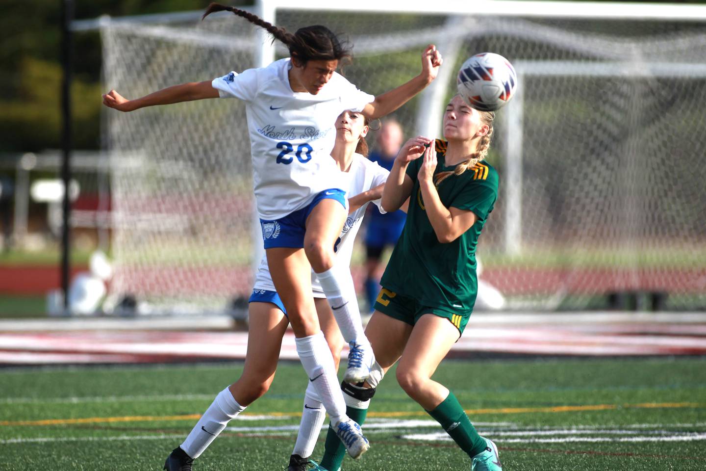 St. Charles North’s Aubri Magana (left) and Fremd’s Sammie Serpico head the ball during the Class 3A state semifinal game at North Central College in Naperville on Friday, May 31, 2024.