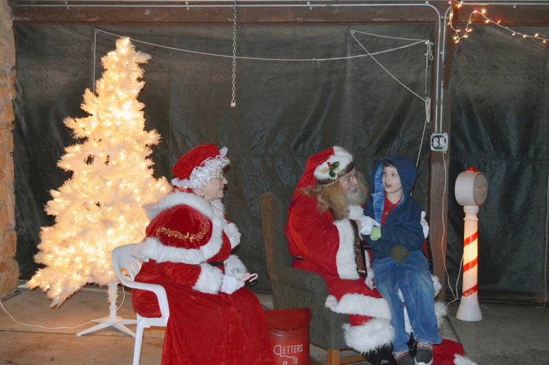 Kooper Norris, 7, of Forreston, talks to Santa and Mrs. Claus about his present wish list in Memorial Park during Forreston's Christmas in the Country on Dec. 2.
