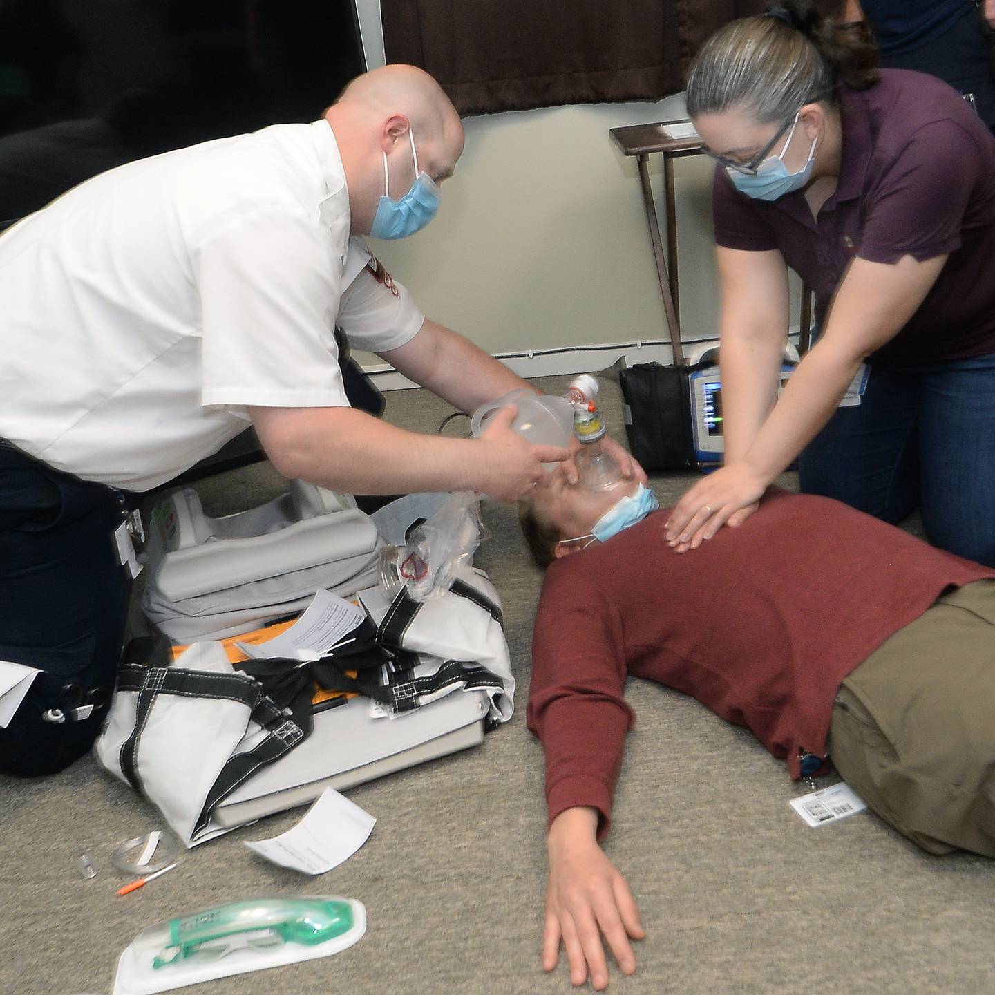 James Walker and Jacquelin Coons, of Advance Medical Transport, begin a demonstration of new donated CPR equipment to the Streator Fire Department. Josh Bradshaw, of AMT, sits in as the example patient.
