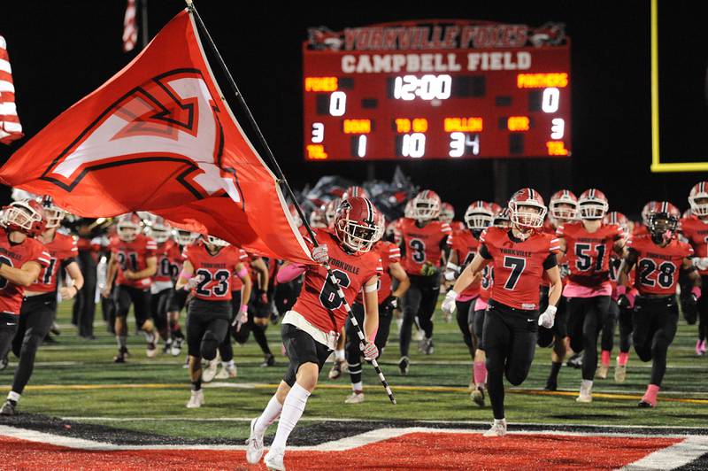 The Yorkville football team runs onto the field before their game with Oswego on Friday, Oct. 11, 2024, at Yorkville High School.