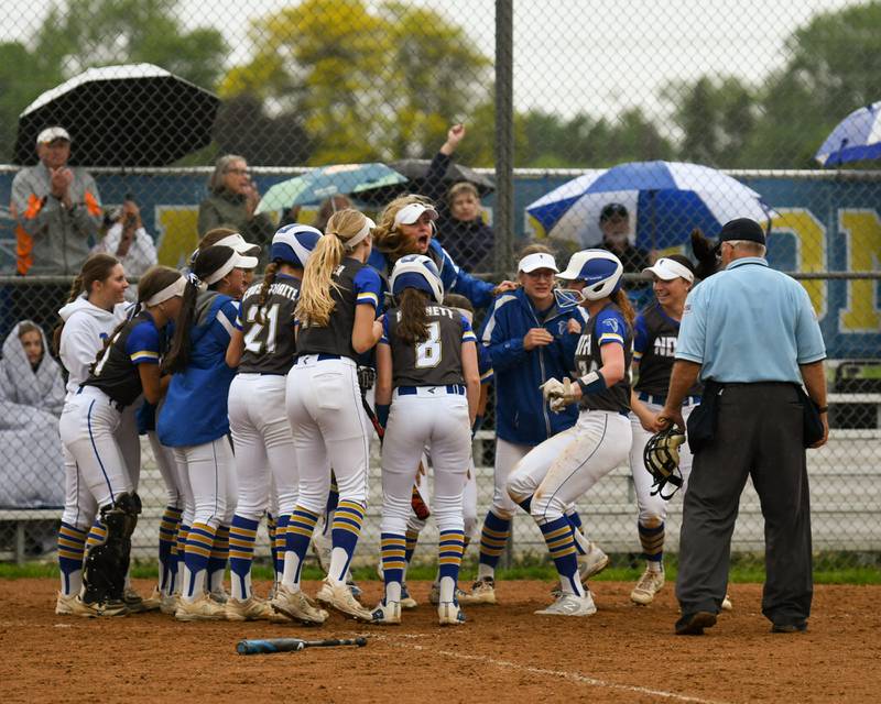 Wheaton North's Monica Kading (24) gets congratulated by teammates after hitting a home run during the game on Monday May 13, 2024, while taking on Glenbard North High School.