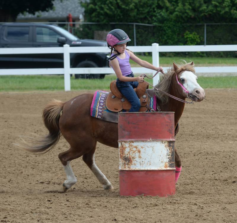 Hadley Vandermyde, 6, of Morrison, manuevers her pony Jubilee around a barrel at the WHOA benefit horse show on Saturday, June 22, 2024 at the Whiteside County fairgrounds in Morrison.