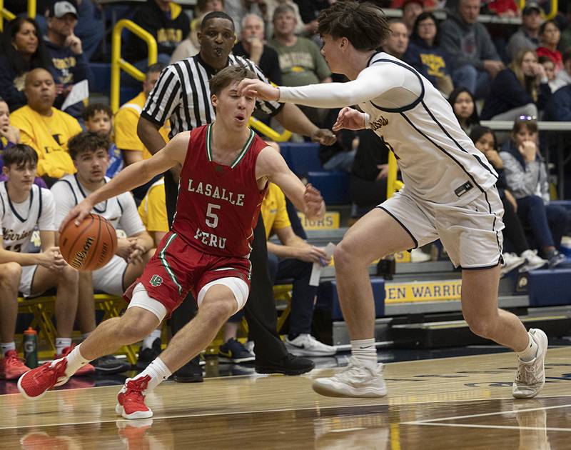 LaSalle-Peru’s Seth Adams handles the ball against Sterling’s Jimmy Wadsworth Friday, Feb. 23, 2024 during a class 3A regional final at Sterling High School.