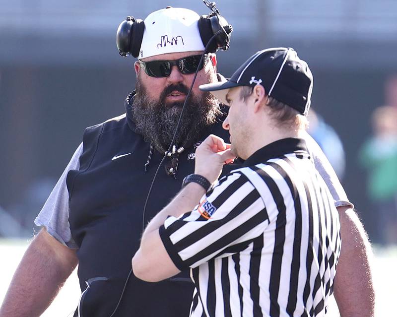 Peoria's head coach Tim Thornton talks to an official during their IHSA Class 5A state championship game Saturday, Nov. 26, 2022, in Memorial Stadium at the University of Illinois in Champaign.