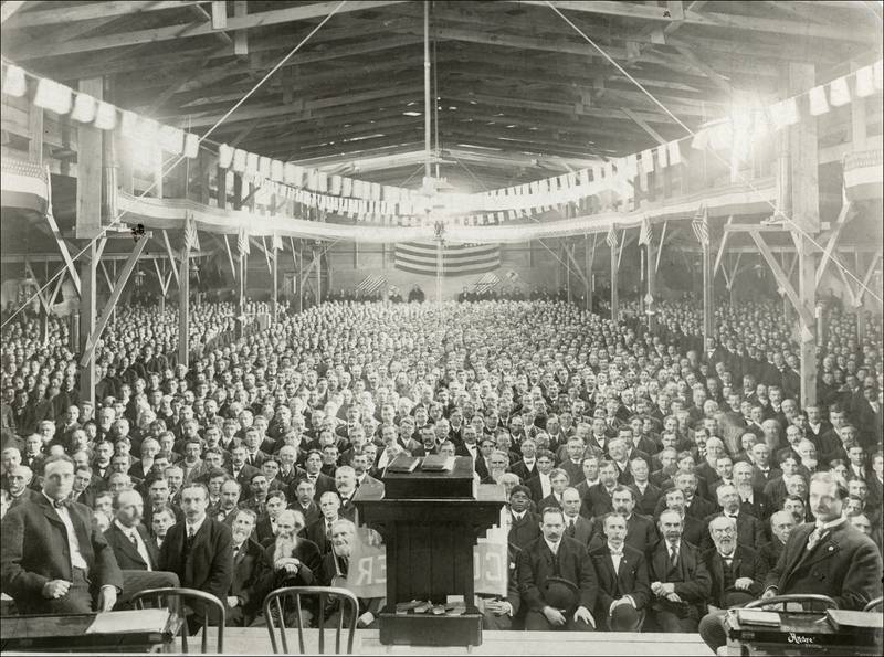 A 3,300 seat tabernacle was built in Dixon specifically for Billy Sunday’s 36 days of revival meetings in February and March of 1905. On the stage at the left is Billy Sunday and on the right is Fred Fischer, Sunday’s song leader who traveled with him. This picture is from one of the meetings held for men but there were separate meetings for the women.