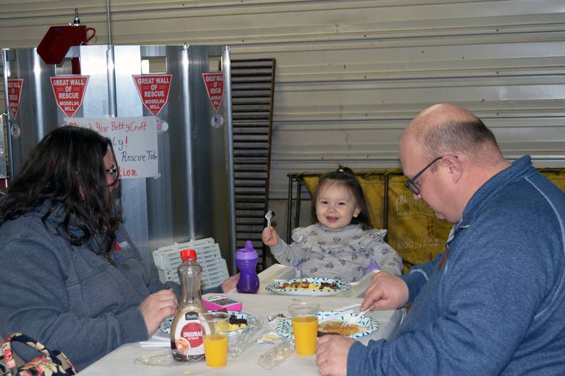 Elizabeth Altfillisch, 2, smiles from her highchair while she and grandparents Becky and Aaron Rogers, of Freeport, eat on Feb. 25, 2023, during the annual Leaf River Firemen's Pancake Supper. A little over 700 people attended the fundraiser at the Leaf River fire station, raising $2,050.