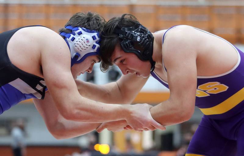 Wauconda’s Joe Scianna, right, tussles with Woodstock’s Andrew Ryan in a 195-pound bout during IHSA Class 2A regional wrestling at Crystal Lake Central Saturday. Ryan won the bout.