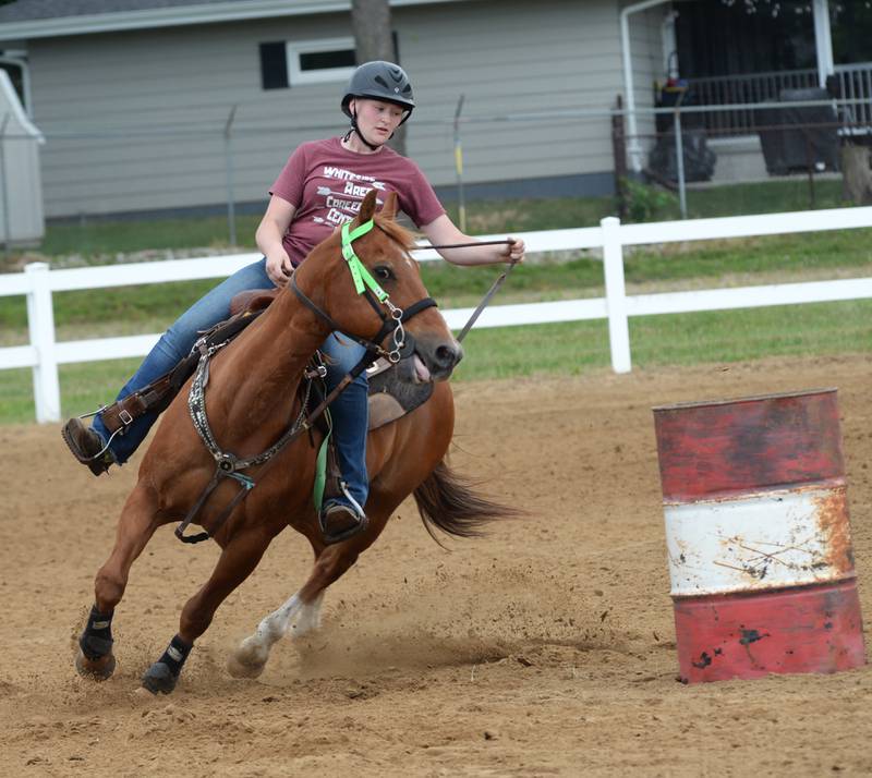 Molly Weinzierl of Dixon steers Reno as they compete in the open division of the barrel racing competition at the WHOA benefit horse show on Saturday, June 22, 2024 at the Whiteside County fairgrounds in Morrison.. Reno is a horse that Weinzierl rescued.
