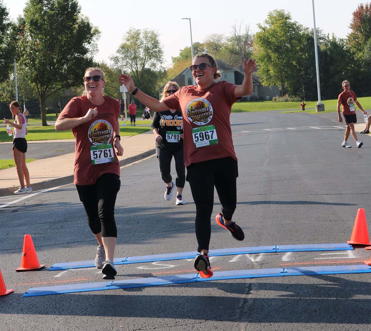 Runners celebrate as they cross the finish line at Morris Hospital’s 2023 Corn Fest 5K Run.