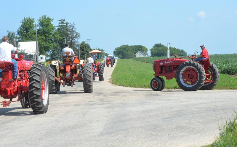 Cliff Jones of Ashton waits to join the Living History Antique Equipment Association's tractor drive on Saturday. About 40 tractors took part in the ride that started at the association's show grounds in Franklin Grove and traveled to Oregon and back. Jones lived along the route and opted to join in at the intersection wth Hoosier Road.