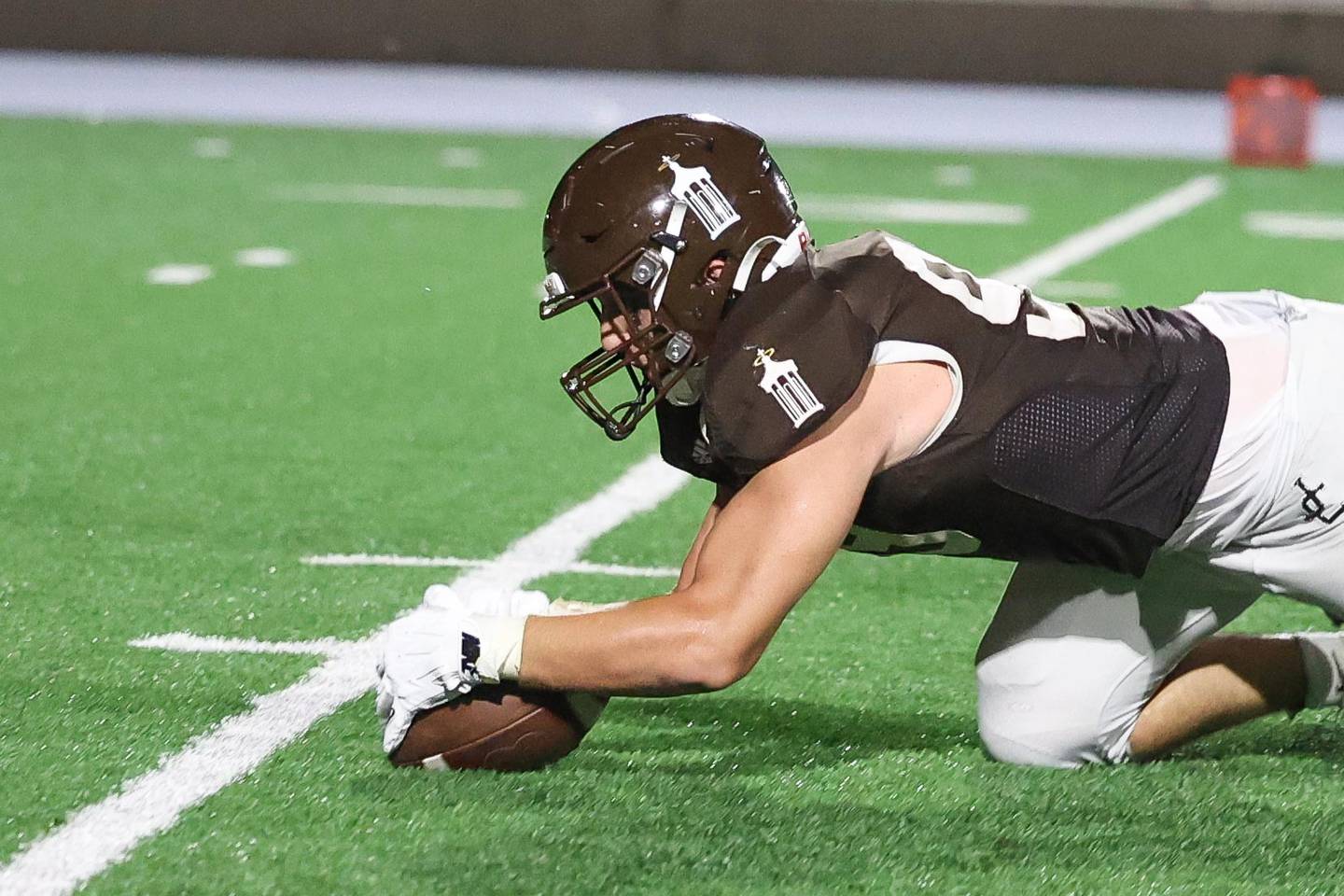 Joliet Catholic’s Ian Campbell recovers the fumble against Iowa City on Friday, August 30, 2024 in Joliet.