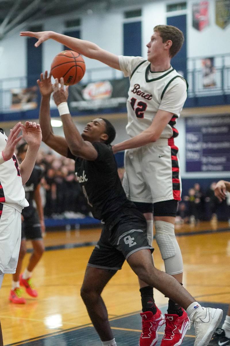 Benet’s Colin Stack (42) blocks a shot by Oswego East's Andrew Wiggins (1) during a Class 4A Oswego East regional final basketball game at Oswego East High School on Friday, Feb 23, 2024.