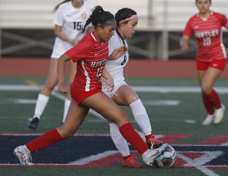 Huntley’s Chloe Pfaff battles with McHenry's Elena Carlos for control of the ball during a Fox Valley Conference soccer match Thursday, April 13, 2023, at Huntley High School.