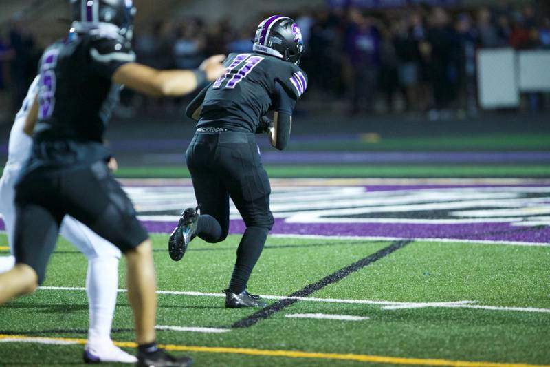 Downers Grove North's Charlie Cruse runs the fumble in for a touchdown against Downers Grove South on Friday Sept. 6,2024 in Downers Grove.