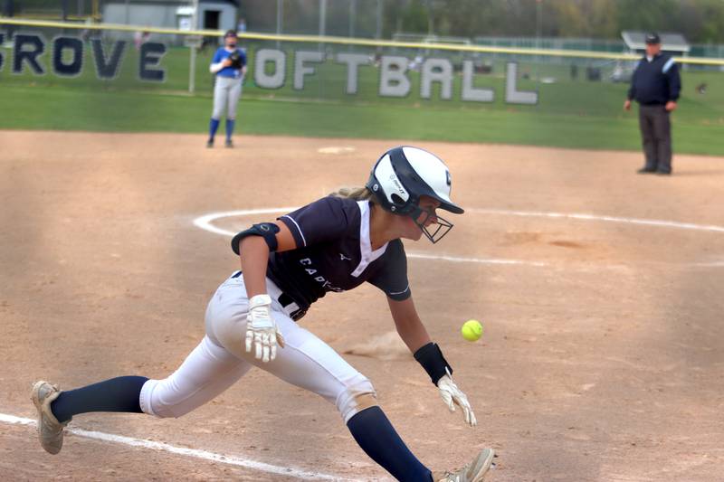 Cary-Grove’s Aubrey Lonergan lunges for home plate on an inside-the-park home run against Burlington Central in varsity softball at Cary Monday.