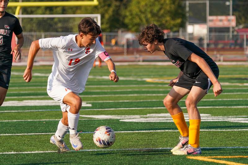 Oswego’s Lucas Ensign (19) plays the ball on the edge of the box against Yorkville's Jack Gleason (6) during a soccer match at Yorkville High School on Tuesday, Sep 17, 2024.