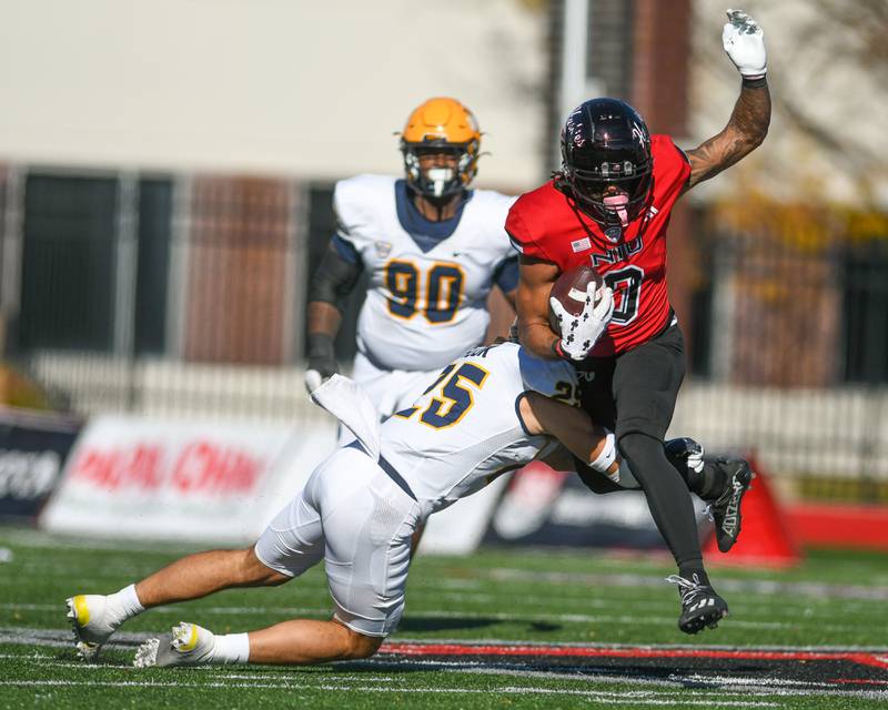 Northern Illinois Huskies wide receiver Cam Thompson (0) gets caught up by Toledo’s Maxen Hook during the game on Saturday Oct. 19, 2024, held at Northern Illinois University.