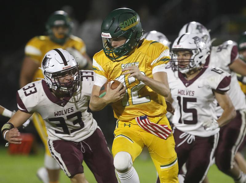 Prairie Ridge's Ethan Hart (left) and Andrew Cioper (right) chase down Crystal Lake South's Aidan Neyt during a Fox Valley Conference football game on Friday, Sept. 6, 2024, at Crystal Lake South High School.