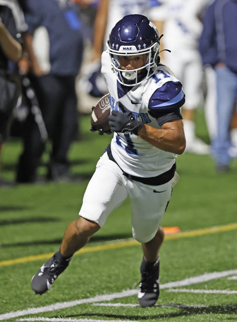 Nazareth's James Penley (11) breaks for a long run during the varsity football game between Nazareth Academy and Mt. Carmel high school on Friday, Sep. 13, 2024 in Chicago.