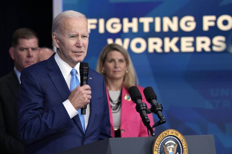 FILE - President Joe Biden speaks as AFL-CIO President Liz Shuler, right, listens, Dec. 8, 2022, in Washington. Facing pressure from within his own party to abandon his reelection campaign, Biden is relying on labor unions to help make the case that his record in office matters more than his age. Biden is set to meet Wednesday, July 10, 2024, with the executive council of the AFL-CIO, America's largest federation of trade unions. "President Biden and Vice President Harris have always had workers' backs — and we will have theirs," Shuler said. (AP Photo/Susan Walsh, File)