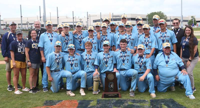 Members of the Marquette baseball team, coaches and faculty pose with the Class 1A championship trophy after defeating Altamont 6-2 on Saturday, June 1, 2024 at Dozer Park in Peoria.