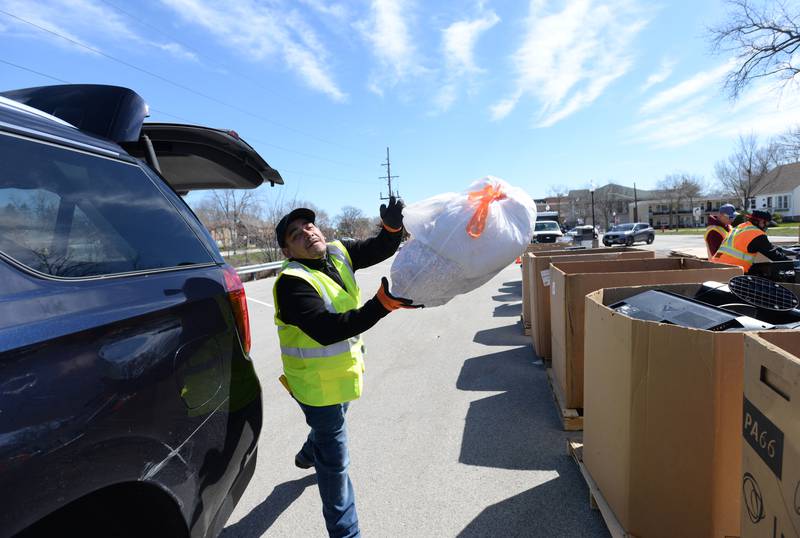 Material Handler for eWorks, Filipe Saltu disposes of recycling materials during the Electronics and More Recycling event held in Westmont Saturday, April 6, 2024.