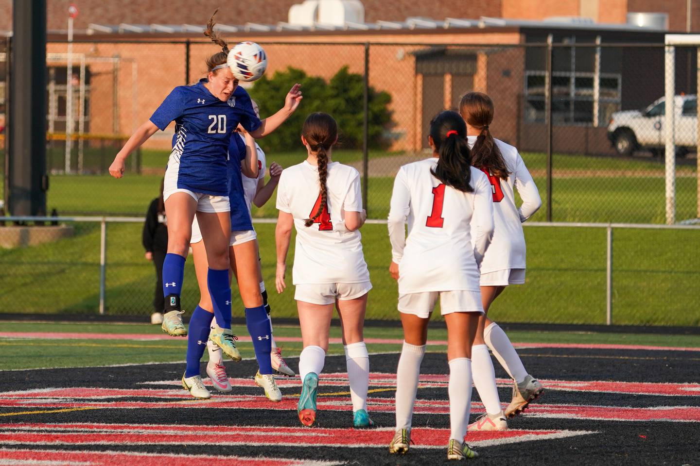 Geneva’s Caroline Madden (20) heads the ball off a corner kick for a goal against Glenbard East during a Class 3A Glenbard East Regional semifinal soccer match at Glenbard East High School in Lombard on Tuesday, May 14, 2024.