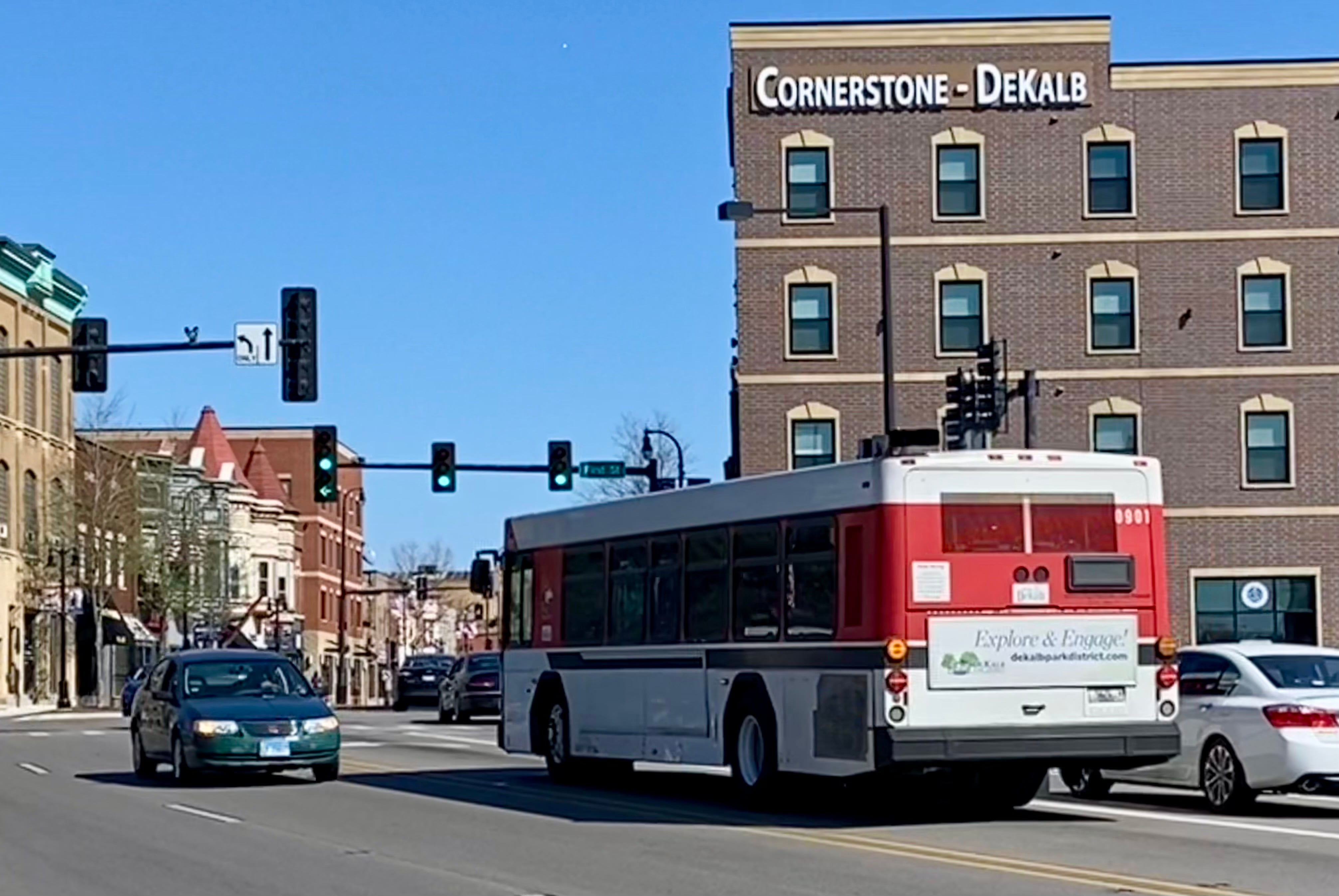 An NIU Huskie bus, part of the city of DeKalb's public transit system, heads east on Lincoln Highway in downtown DeKalb Monday, April 15, 2024.