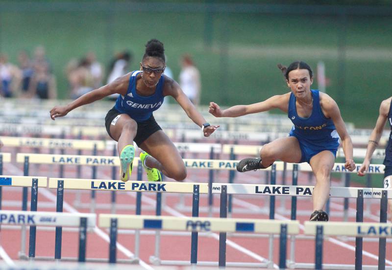 Geneva’s Alyssa Flotte (left) and Wheaton North’s Sophie Dalrymple compete in the 100-meter hurdles during the DuKane Conference Girls Outdoor Championships at Lake Park in Roselle on Thursday, May 2, 2024.