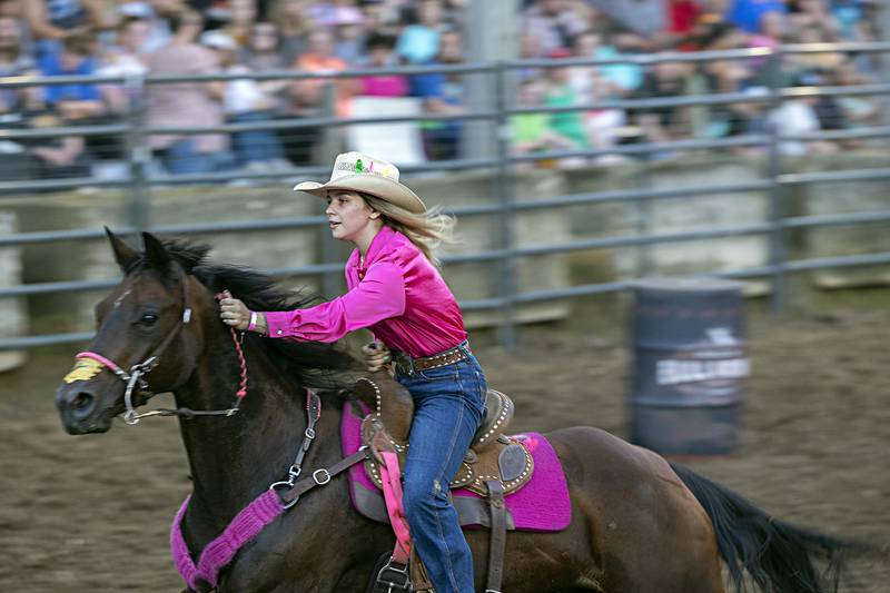 Kinley Northrup eyes the next barrel in the Rice Bull Riding and Barrel Racing event Thursday, August 11, 2023 at the Carroll County fair.