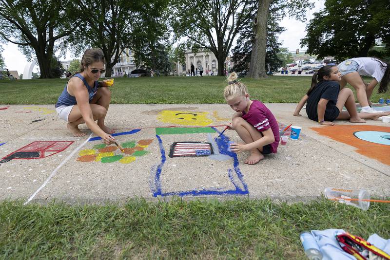 Jaselyn Nagy and daughter Lola, 8, paint the seasons for the their art piece Monday, July 3, 2023 at Petunia Fest’s Brush and Bloom.