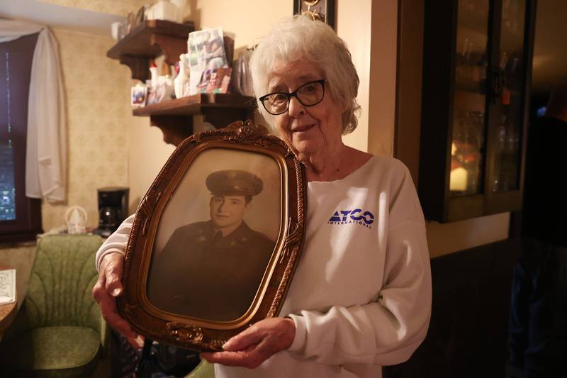 Barbara Lee Cerney holds a photo of her brother PFC Bryan Myers Jr. shortly after he inlisted into the Army at her home in Shorewood on Friday, May 24, 2024. PFC Bryan Myers Jr.’s remains were recently returned to family after being kill in Korea in 1950.