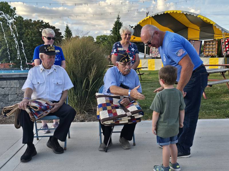 Dominic Rivara is congratulated Sunday, Sept. 15, 2024, after receiving a Quilt of Valor at Senica Square in Oglesby.