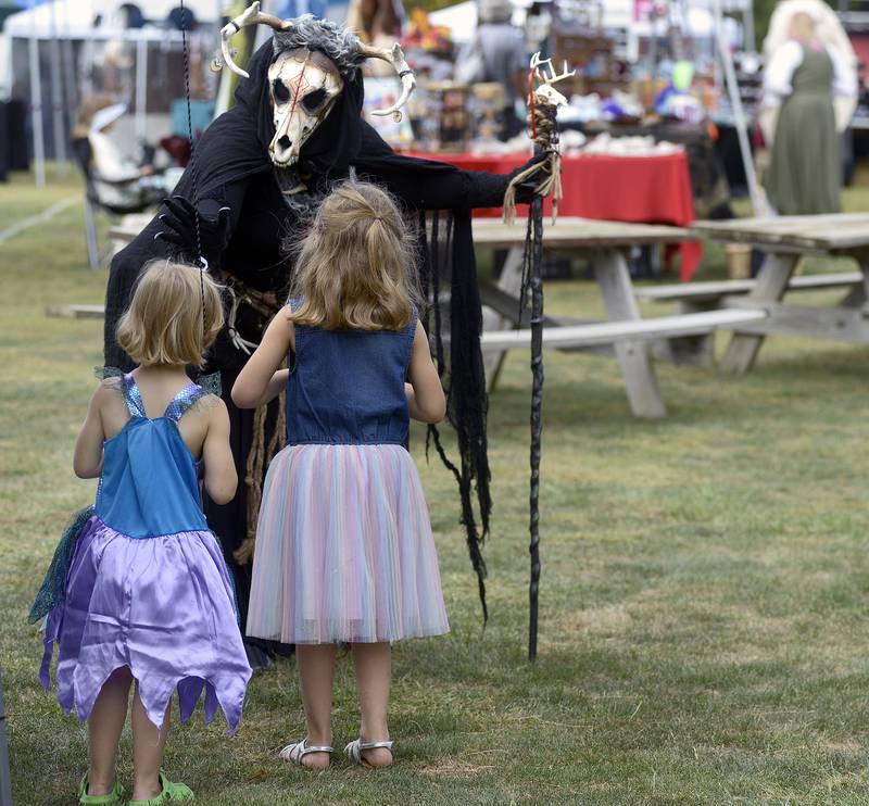 “Ember” along with “Mini Me” on a stick strolls the grounds Saturday, Sept. 14, 2024, of the Marseilles Renaissance Faire, and stops to visit with children.