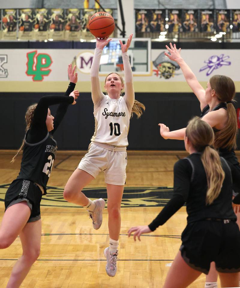 Sycamore's Lexi Carlsen shoots between three Kaneland defenders during their Class 3A sectional semifinal Tuesday, Feb. 20, 2024, at Sycamore High School.