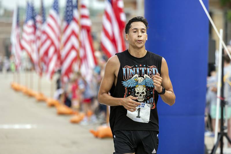 For the fourth time, Jacob Gebhardt of Sterling takes the checkered flag at the Reagan Run in Dixon on Saturday, July 1, 2023. Gebhardt crossed the finish with a time of 15:07.