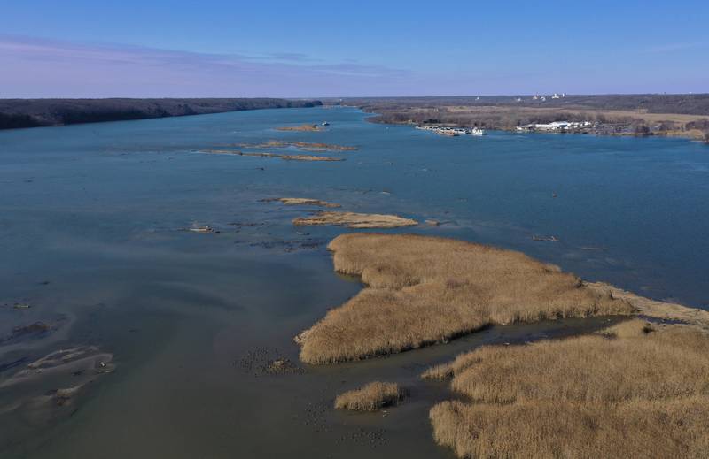 An aerial view of Delbridge Island looking west toward the Starved Rock Lock and Dam on Tuesday, Feb. 13, 2024 near Starved Rock State Park. The Starved Rock Breakwater project is a habitat restoration effort designed to restore submerged aquatic vegetation in the Illinois River, Starved Rock Pool. It will increase the amount and quality of resting and feeding habitat for migratory waterfowl and improve spawning and nursery habitat for native fish.
Construction of the breakwater will involve placement of riprap along northern edge of the former Delbridge Island, adjacent to the navigation channel between River Mile 233 and 234. The breakwater structure will be approximately 6,100 feet long and constructed to a design elevation 461.85 feet, providing adequate protection to allow for submerged aquatic vegetation growth.
The estimated total cost of this project is between $5 and $10 million.