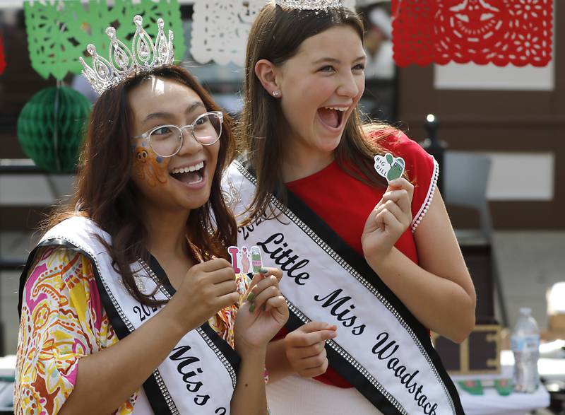 Anne Victoria Perez, the 2024 Miss Woodstock and Gia Galli, the 2024 Little Miss Woodstock show of their prizes they won from tossing pickles at the Claussen booth during the annual Hispanic Connections Mexican Independence Day Celebration on Sunday, Sept. 15, 2024, in the Historic Woodstock Square. The celebration featured music, food and culture.