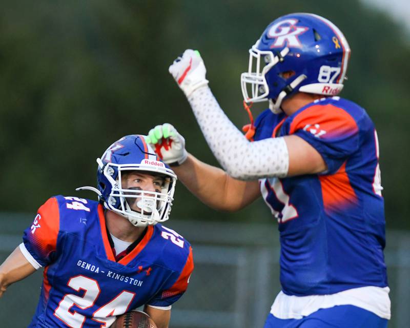 Genoa-Kingston's Haden Hodgson, right, celebrates with teammate Patrick Young (24) after scoring a touchdown in the first quarter on Friday Aug. 30, 2024, while taking on Leo High School held at Genoa-Kingston High School.