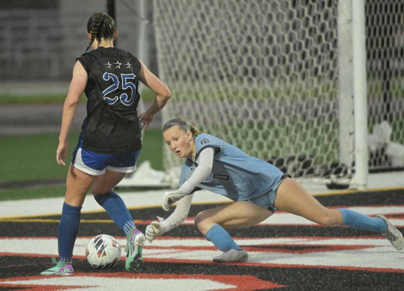 Winnetka New Trier High School goalkeeper Annie Fowler stops a charge by St. Charles North High School’s Kaitlin Glenn in the IHSA Class 3A championship game at North Central College in Naperville on Saturday, June 1, 2024.