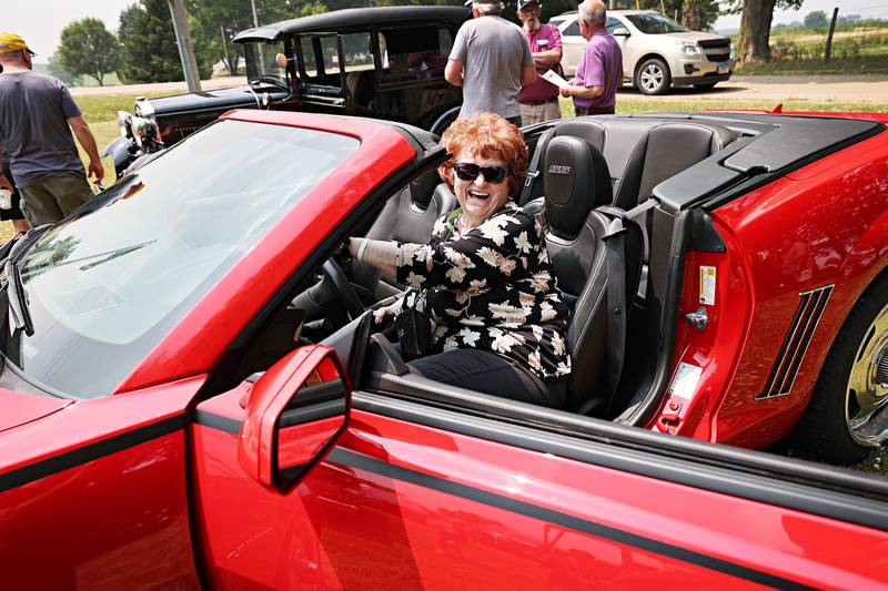 Franklin Grove Assisted Living resident Sandy Pankhurst reacts to a “tire squealing” comment as she checks out a new Camaro Friday, June 23, 2023.