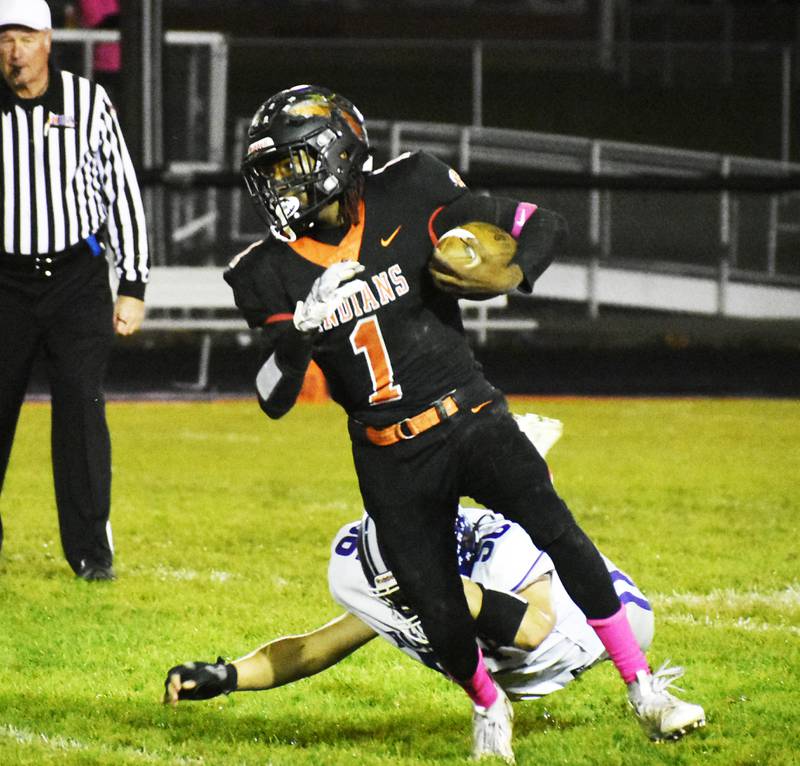 Sandwich running back Simeion Harris avoids a tackle from Rochelle defender Ryan Senne during Interstate 8/Kishwaukee River Conference action Friday night.