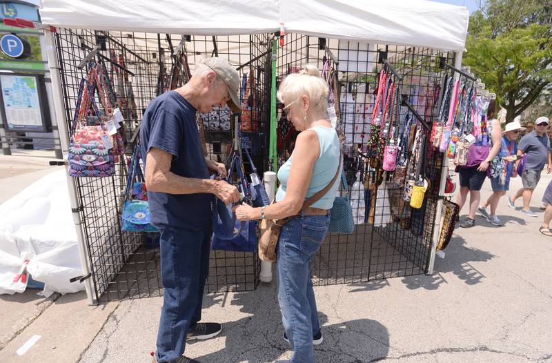 Ron and Diane Harn of Homer Glen look inside one of the hand made purses while attending the LaGrange Craft Fair held Saturday, July 13, 2024.