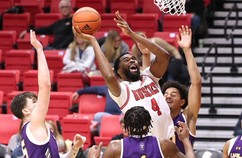 Northern Illinois Huskies forward Oluwasegun Durosinmi goes to the basket between three Albany defenders during their game Tuesday, Dec. 20, 2022, in the Convocation Center at NIU in DeKalb.