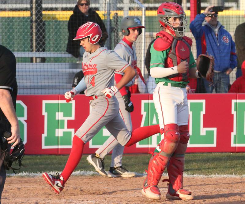 Ottawa's Cam Loomis runs across home plate past L-P's catcher Seth Adams to score a run at Huby Sarver Field inside the L-P Athletic Complex on Tuesday, April 23, 2024 in La Salle.