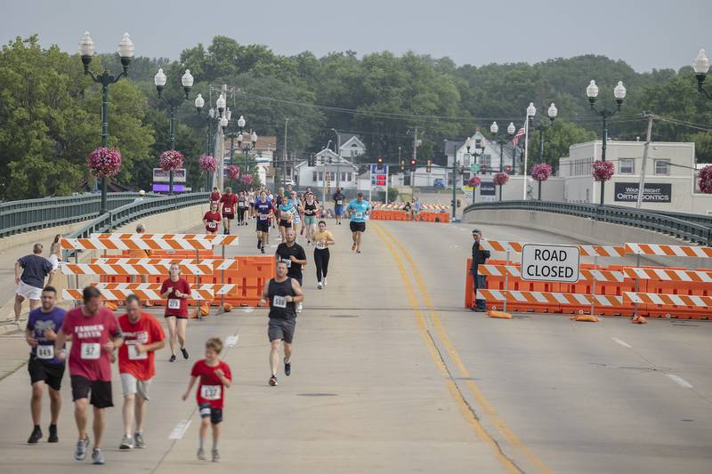 Runners cross the Peoria Avenue bridge Saturday, July 1, 2023 during the last leg of the Reagan Run.