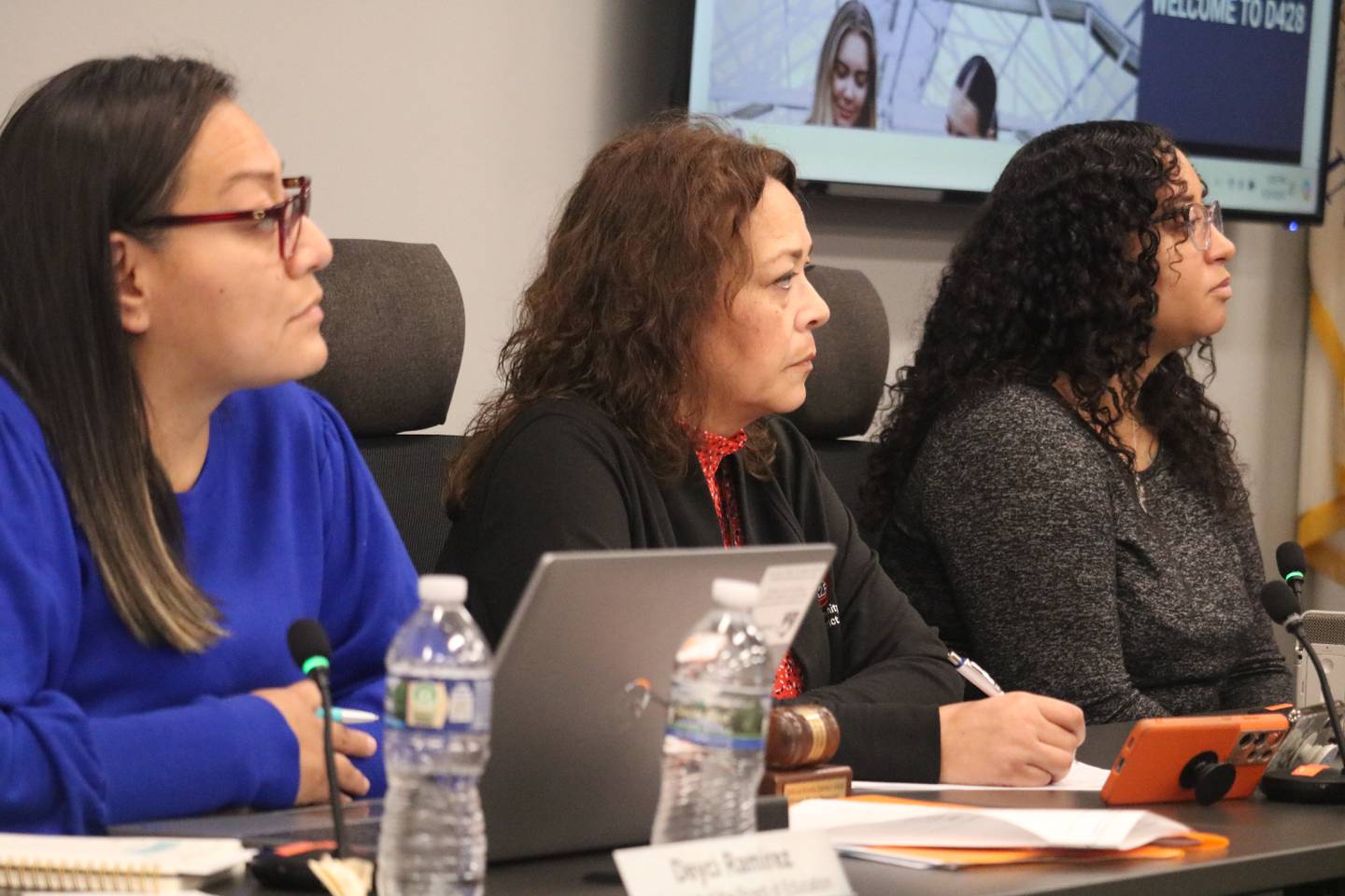 (From left) DeKalb School District 428 school board president Deyci Ramirez, district Superintendent Minerva Garcia-Sanchez and school board secretary Ariel Owens listen to remarks at a DeKalb school board meeting on Tuesday, Aug. 20, 2024.