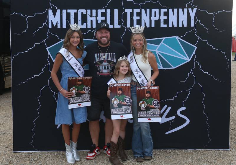 (From left) Stella Denny , Junior Miss Bureau County Fair, Country star Mitchell Tenpenny,  Charlee Kruse, Little Miss Bureau County Fair. and Hannah Hubinsky, 18 of La Salle  Miss Bureau County Fair queen posses for a photo during the 169th Bureau County Fair on Thursday, Aug. 22, 2024 in Princeton.